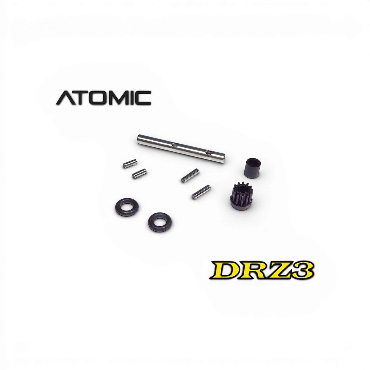 Arbre principal arrière et accessoires pour modèle RC Atomic RC Mini, pièce détachée, en plastique noir avec composants métalliques visibles.