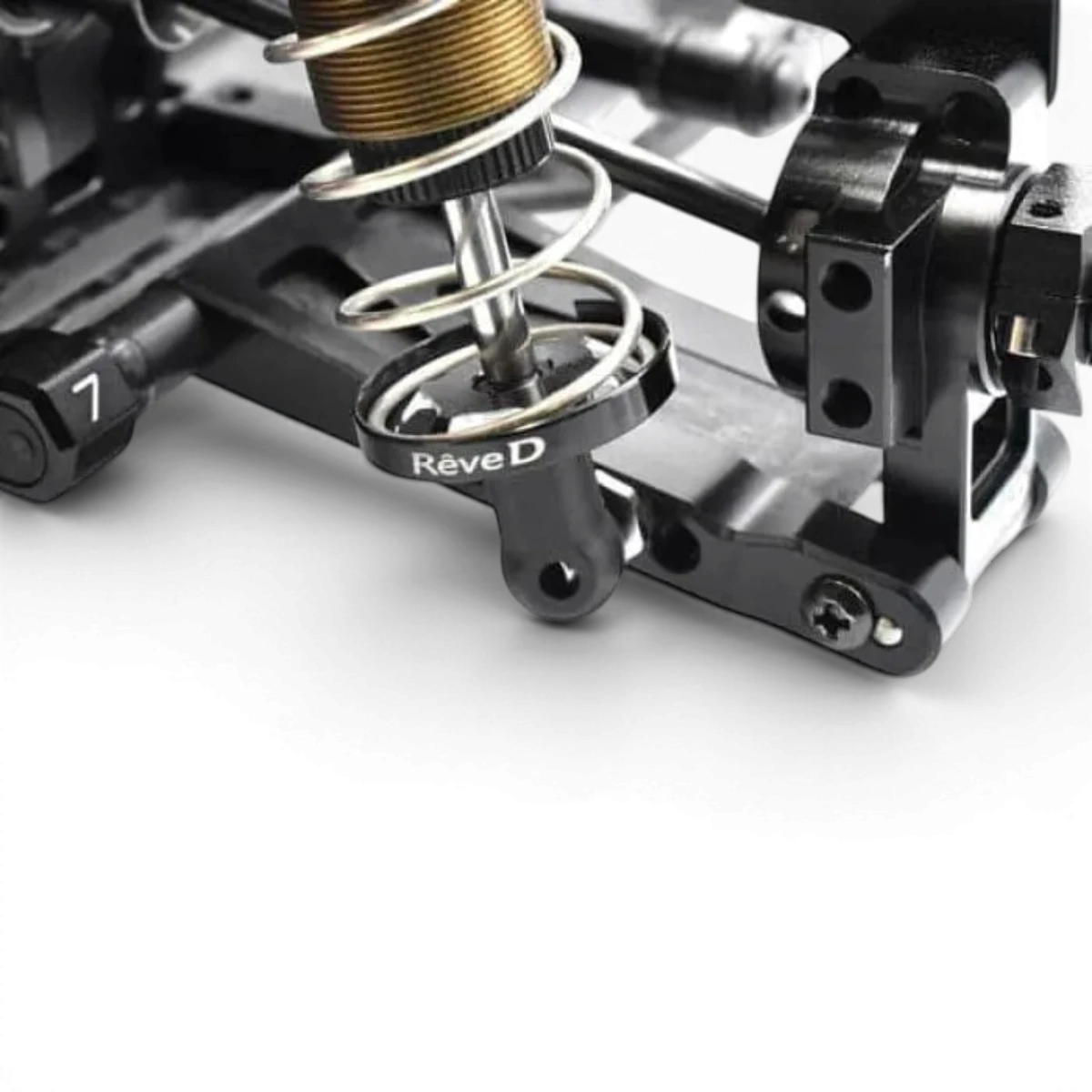 Axes pour amortisseurs BigBore Yokomo, marque Team Reve D, montrant les axes en métal pour suspension de voiture RC.