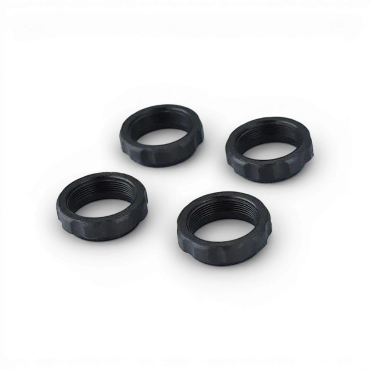Jeu de 4 bagues ressorts amortisseurs RDX pour voiture, fabriquées par Team Reve D, visibles en gros plan sur l'image.