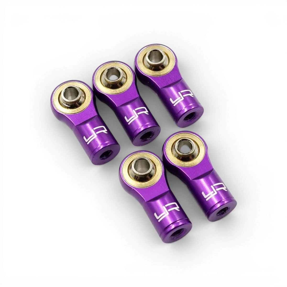 Chapes en aluminium violet pour modèles réduits, fabriquées par Yeah Racing, avec finition pas standard et détails visibles.