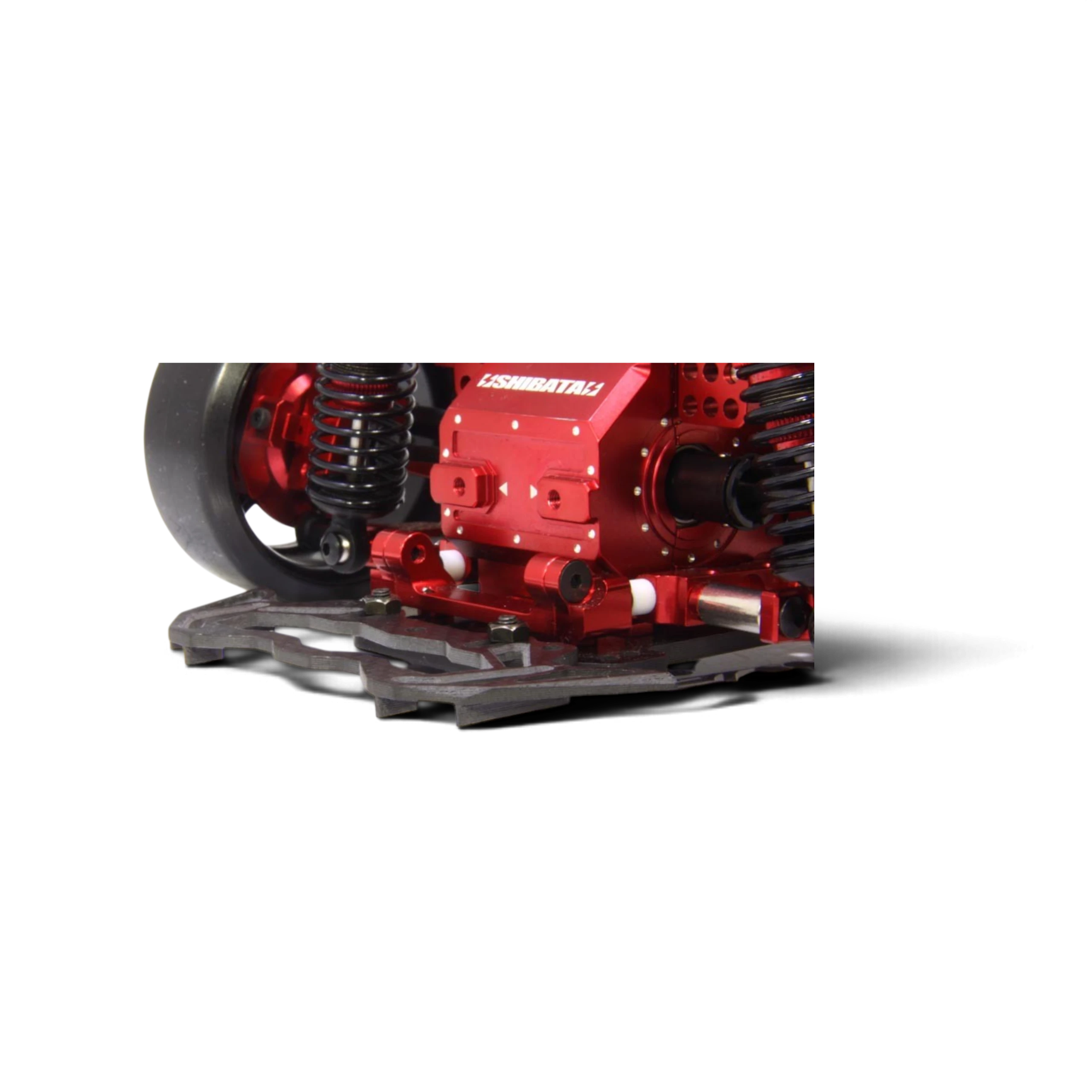 Pare-chocs en carbone brillant DriftParadiZ avec ailettes aérodynamiques monté sur un châssis RC rouge