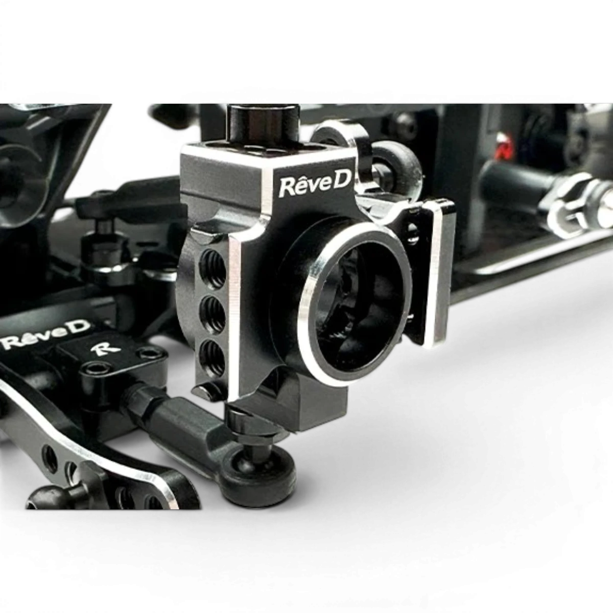 Fusée arrière droite pour voiture RC Drift Team Reve D, pièce de rechange en plastique noir avec fixation métallique visible.