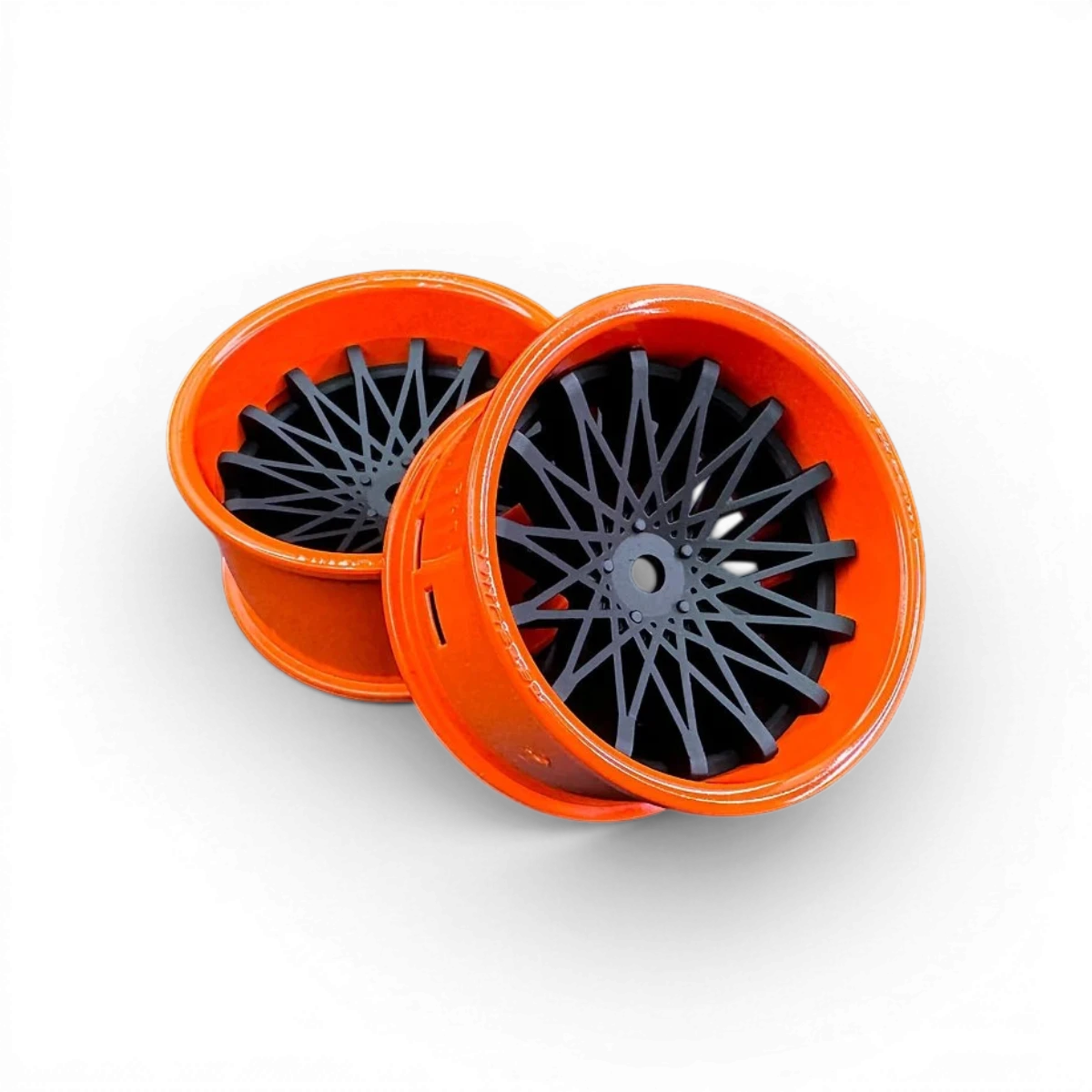 Deux roues Tetsujin avec cerclage orange brillant et centre Dahlia, disque noir mat, pour vélo ou roue de sport.