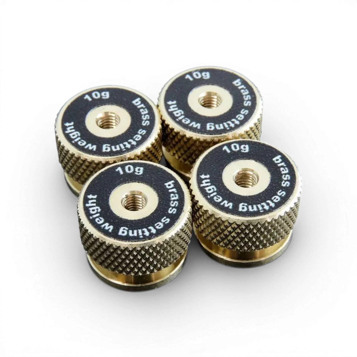 Quatre poids de réglage en laiton de 10g, pièces détachées de la marque Wrap-UP next, pour ajustements précis.