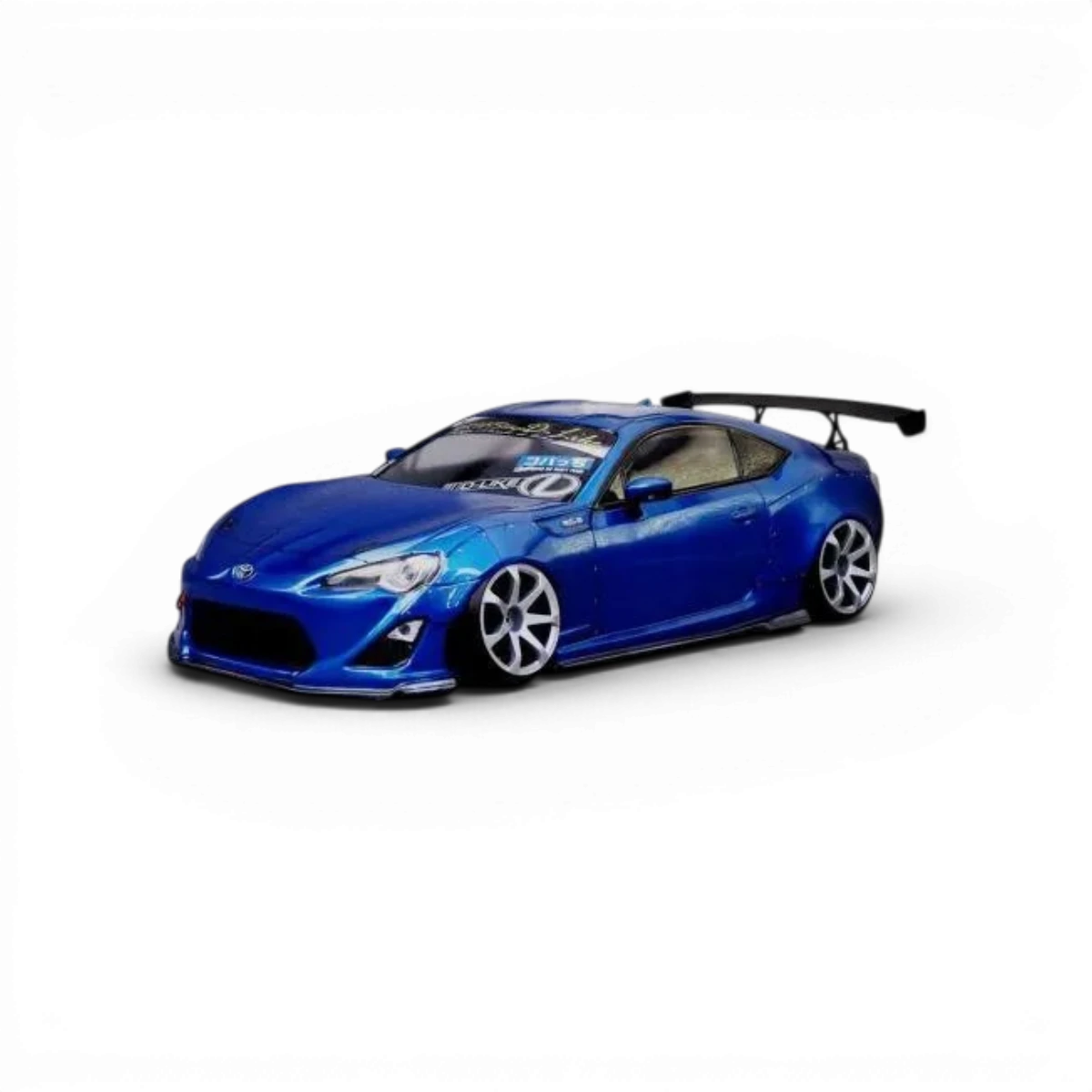 Voiture Toyota GT86 Rocket Bunny, carrosserie modifiée, avec kit aérodynamique D'like, vue de côté sur fond blanc.