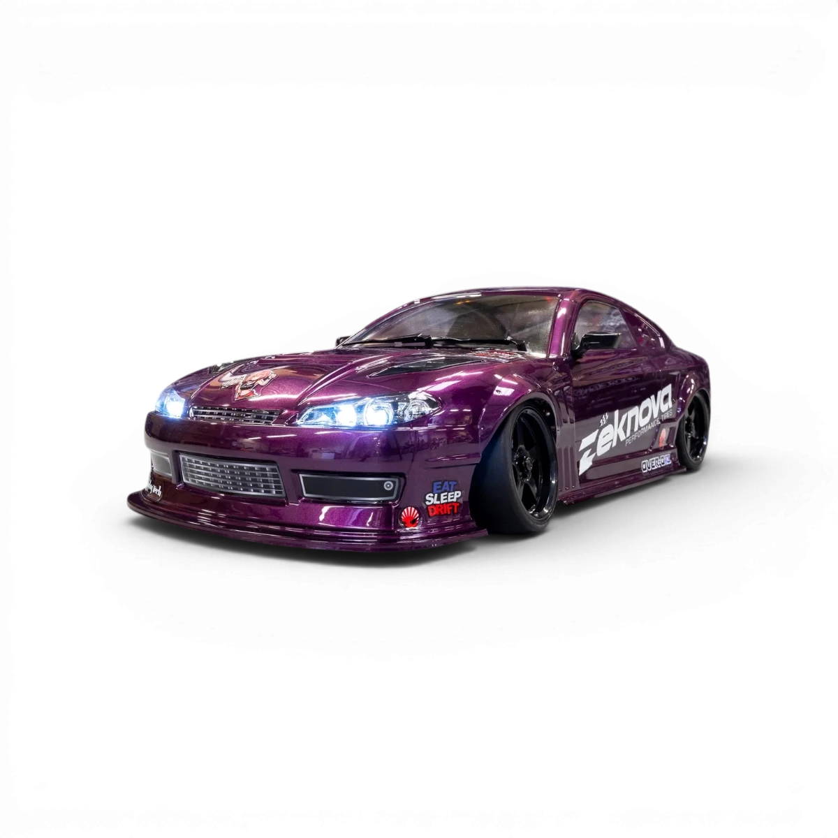 Châssis RC drift HOBBYTECH OVER-D10 RTR brushless RWD avec pneus et composants visibles, pour voitures radiocommandées.