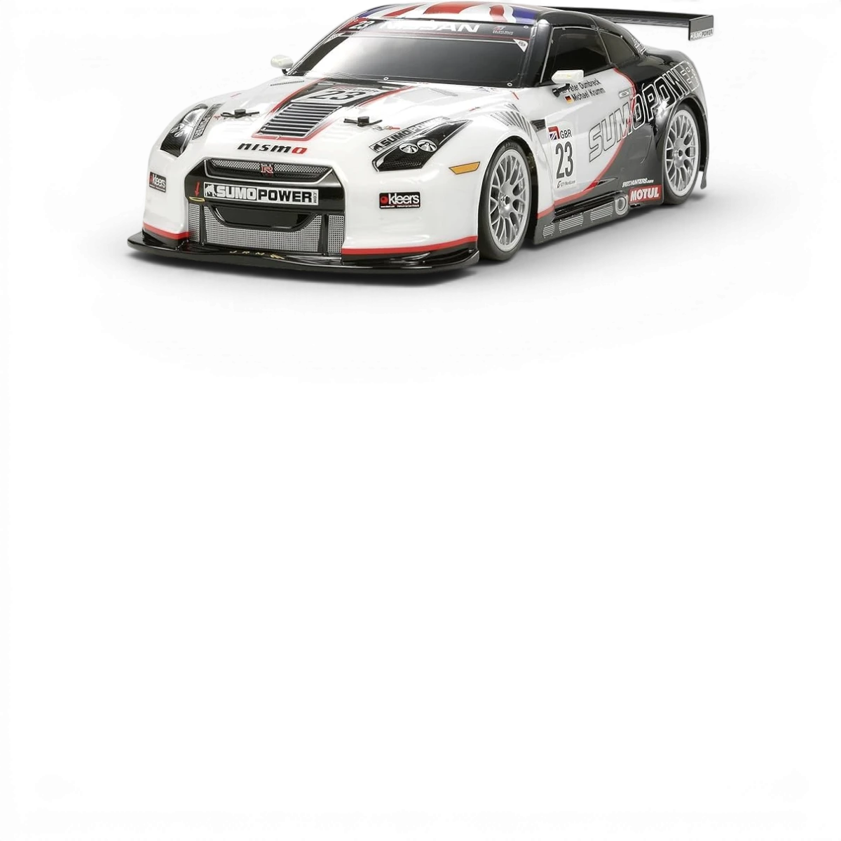 Carrosserie Tamiya Nissan GTR Sumo Power pour voiture RC, détail de la coque en plastique blanche avec logos et design.