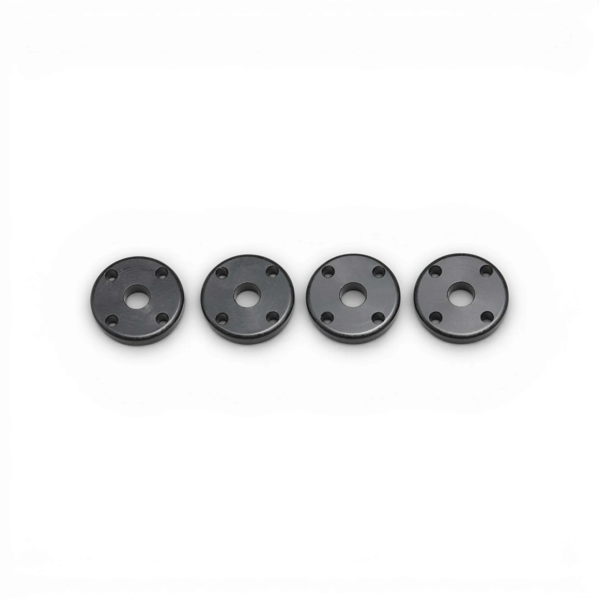 Pistons 4 x 1,4 mm pour amortisseur Big Bore, pièces détachées de la marque Team Yokomo, visibles en gros plan.