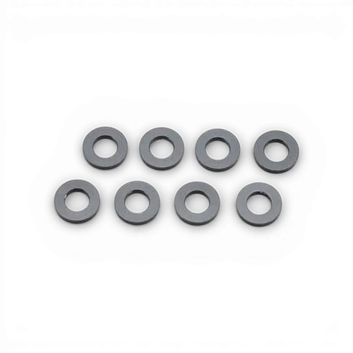 Rondelles noires 3x6x1 en pièces détachées pour modélisme, de la marque Team Yokomo, visibles en premier plan.